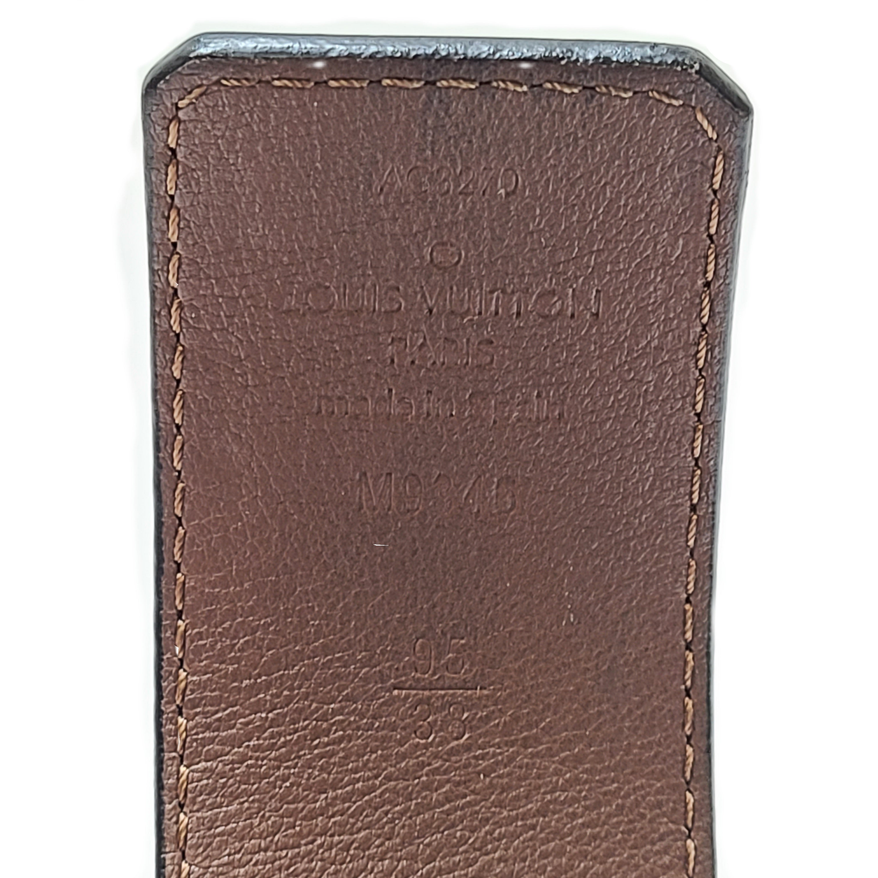 A black Louis Vuitton leather belt with monogram pattern, polished buckle, and Louis Vuitton Paris stamp.