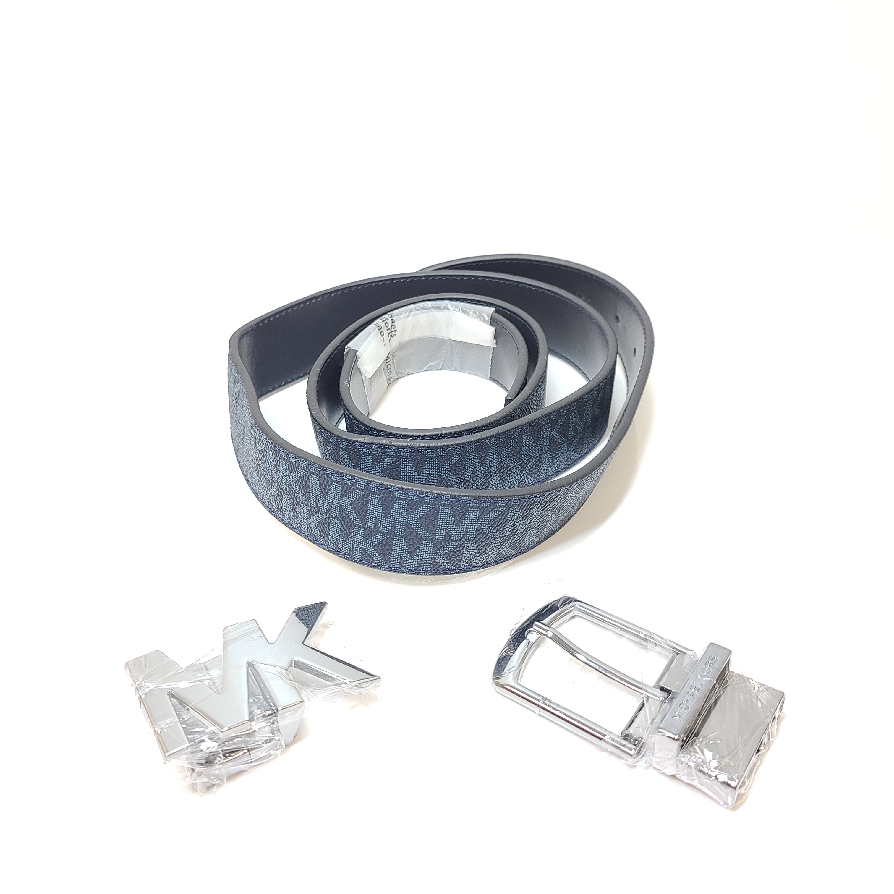 A reversible Michael Kors leather belt in blue and black with an MK logo buckle and a standard buckle.