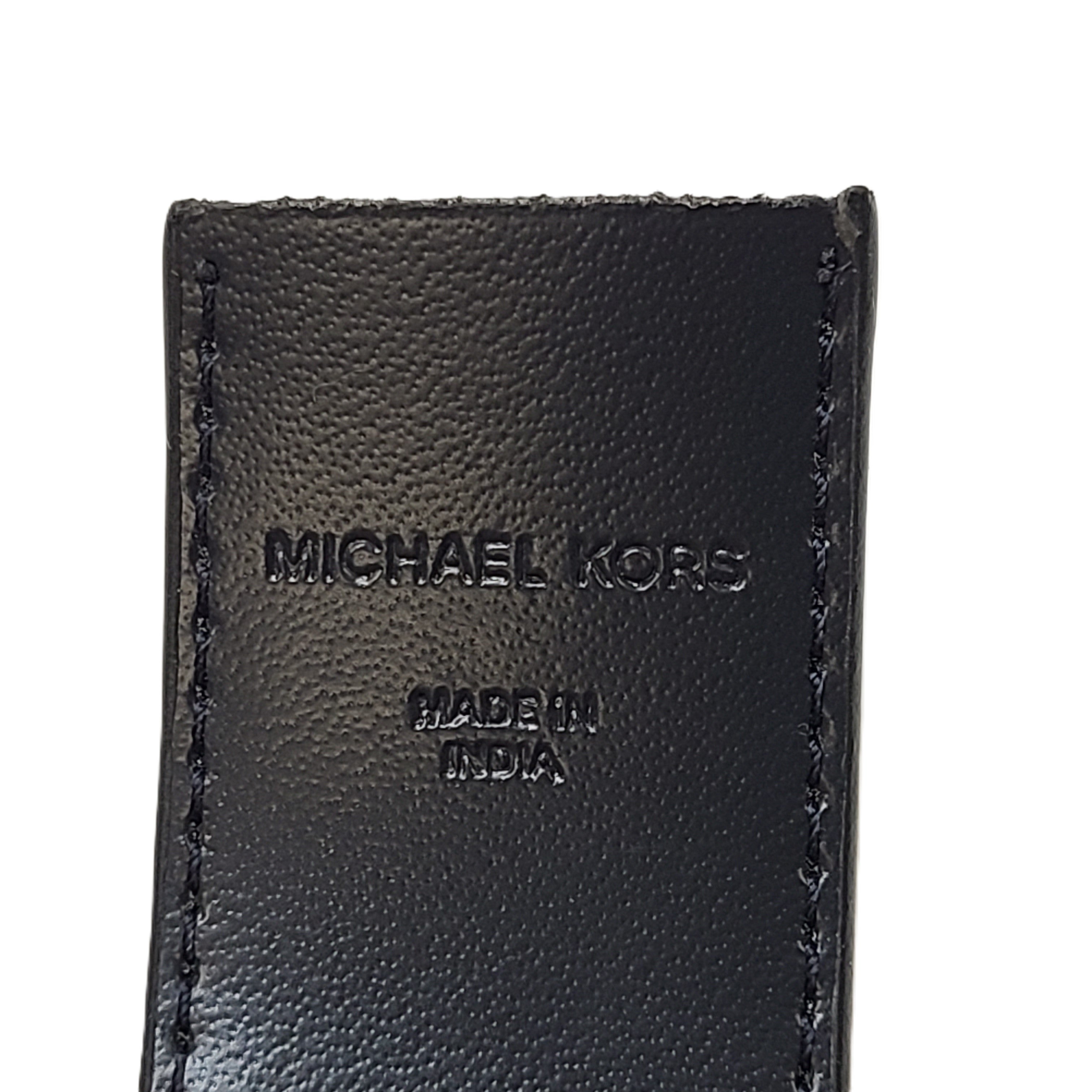 A reversible Michael Kors leather belt in blue and black with an MK logo buckle and a standard buckle.