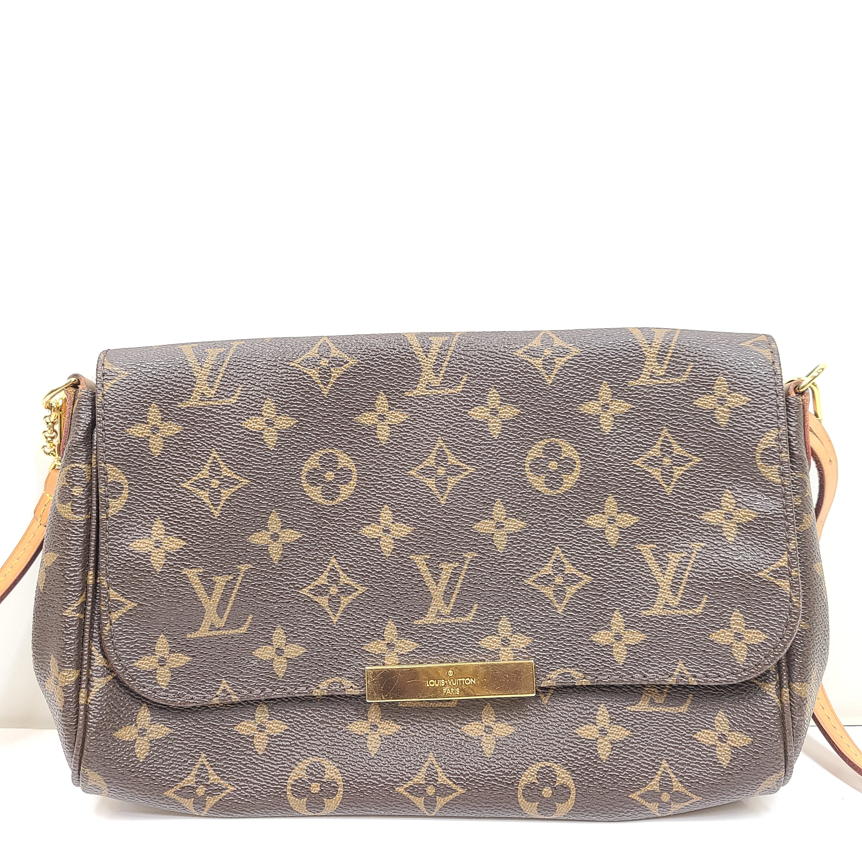 Louis Vuitton Monogram Canvas brown handbag, model DU1165, with classic monogram and leather trim.