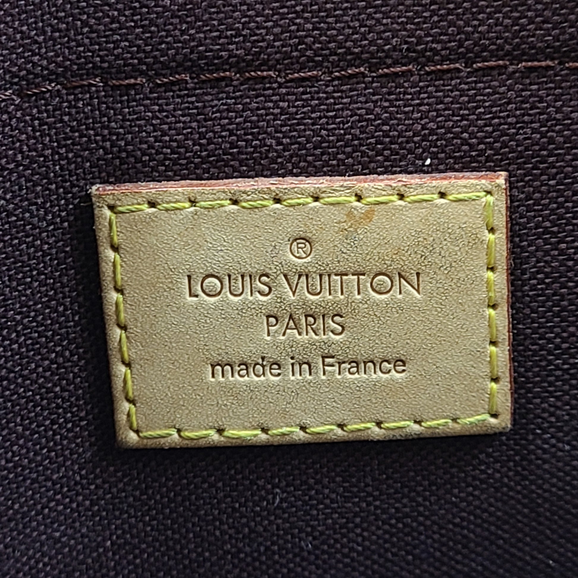 Louis Vuitton Monogram Canvas brown handbag, model DU1165, with classic monogram and leather trim.