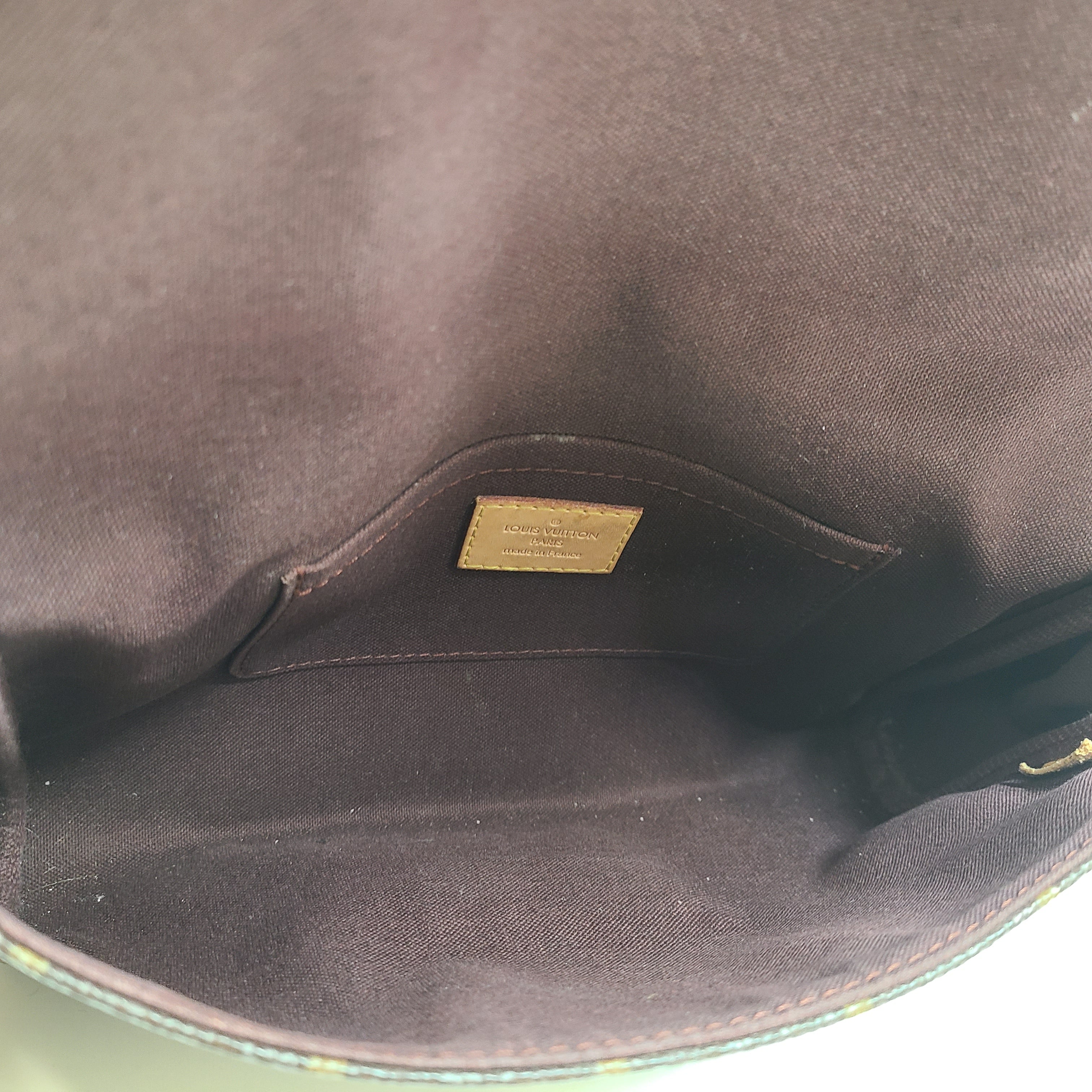 Louis Vuitton Monogram Canvas brown handbag, model DU1165, with classic monogram and leather trim.