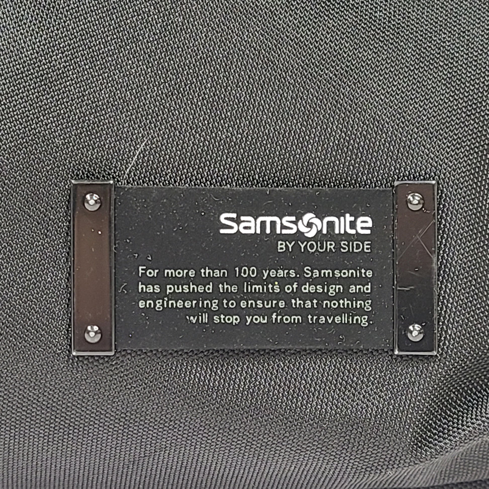 Black Samsonite laptop bag crafted from polyester and microfiber with a slim travel profile and padded laptop compartment.