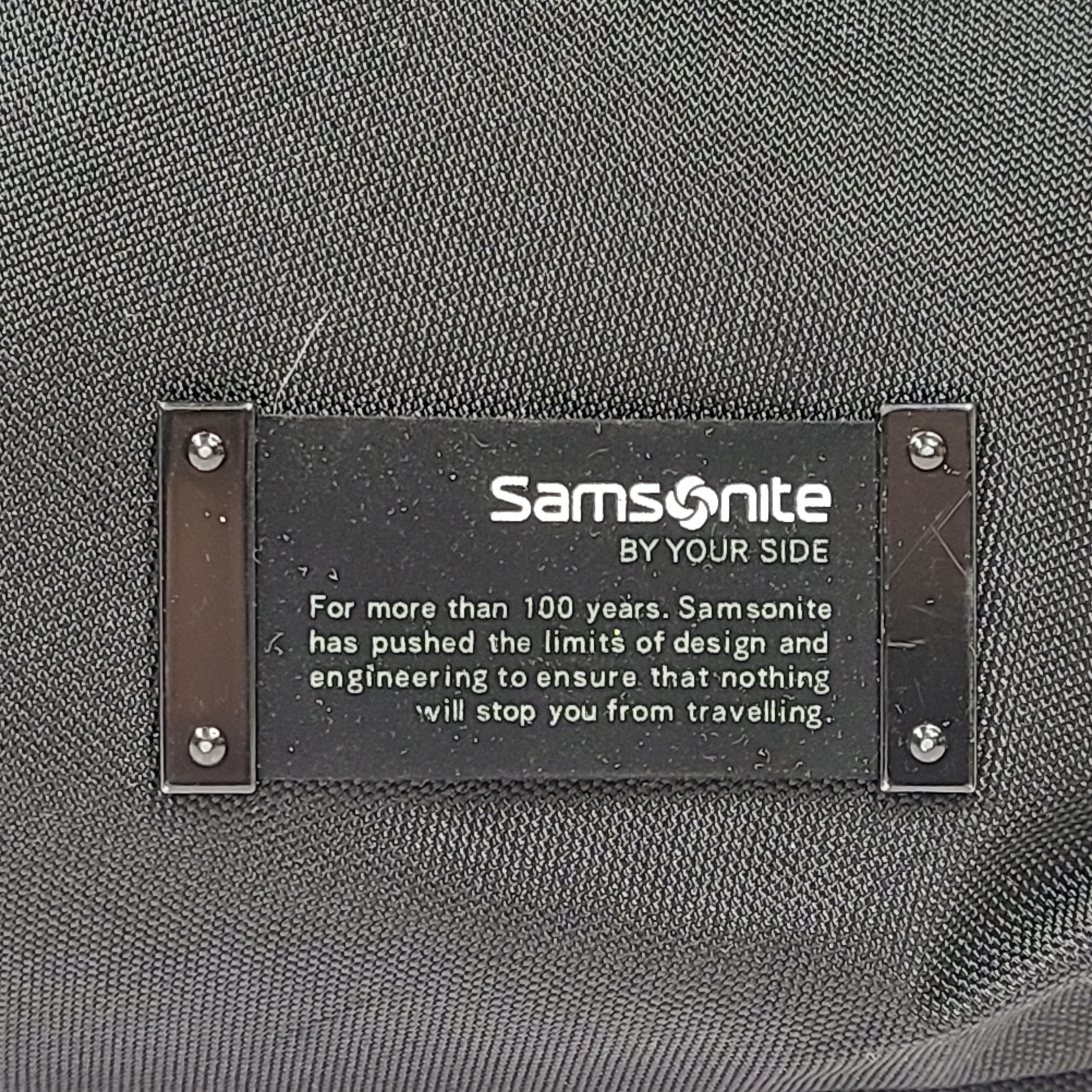 Black Samsonite laptop bag crafted from polyester and microfiber with a slim travel profile and padded laptop compartment.