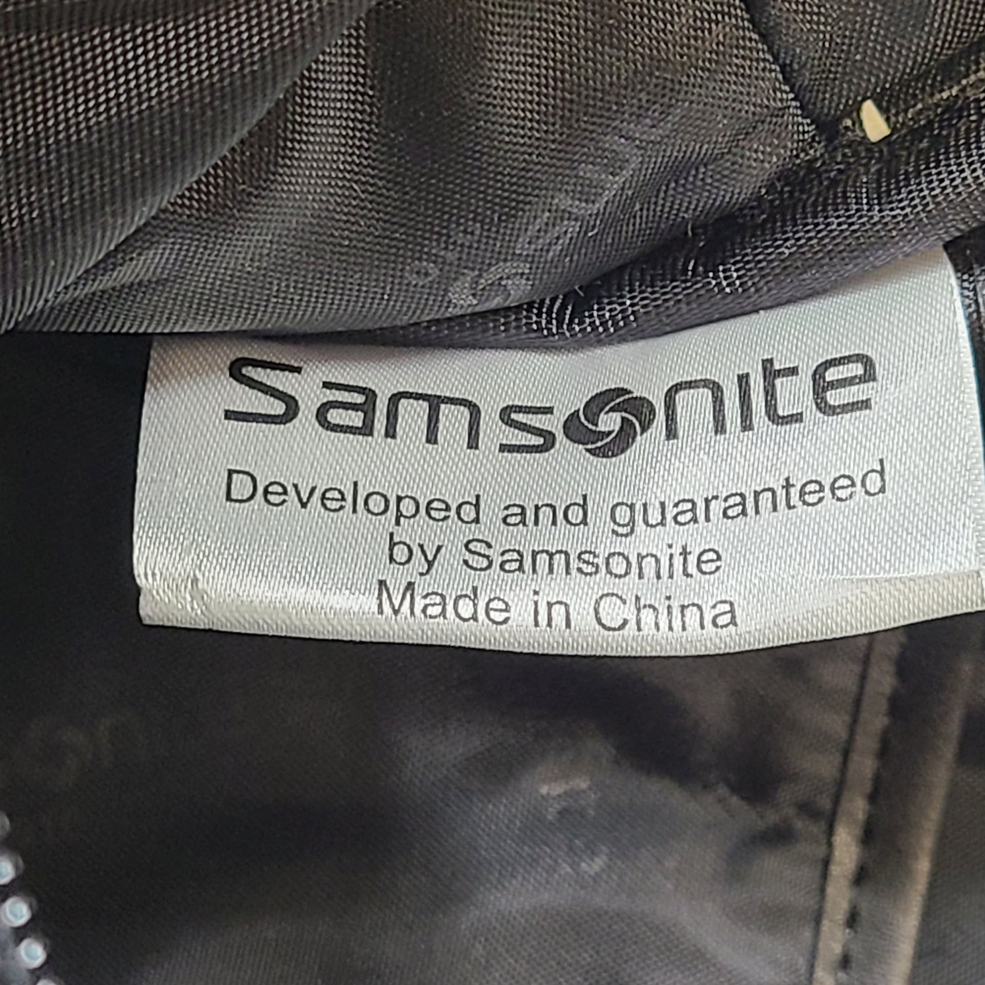 Black Samsonite laptop bag crafted from polyester and microfiber with a slim travel profile and padded laptop compartment.