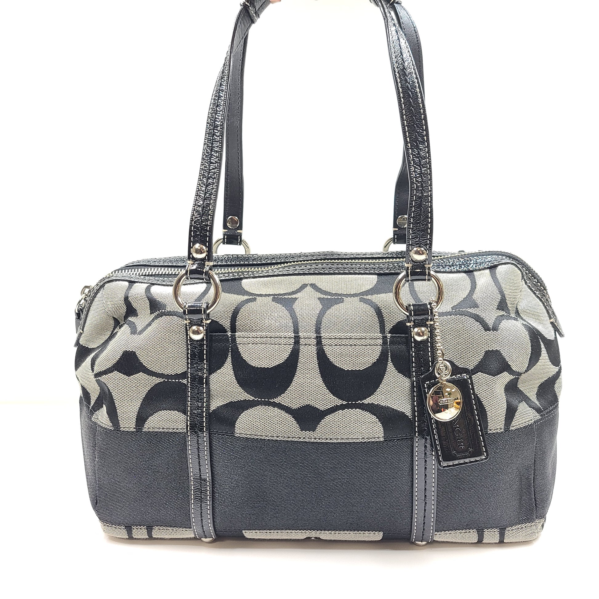 Gray and black Coach satchel with double handles, zip closure, and an interior patch stating handcrafted Coach leather.