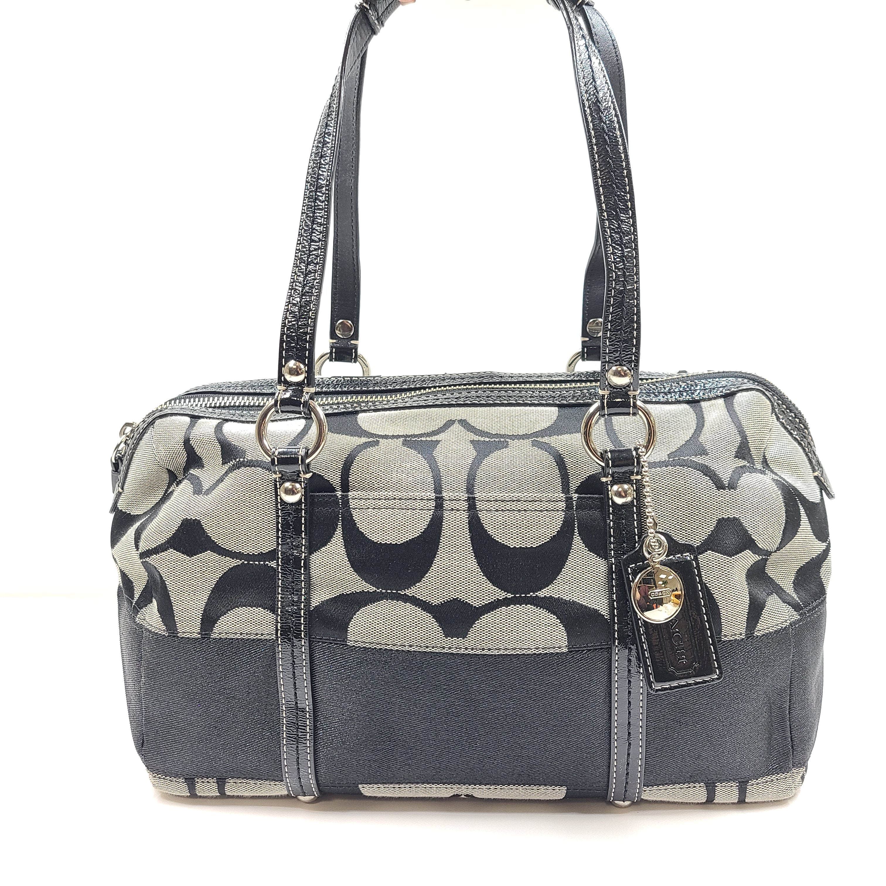 Gray and black Coach satchel with double handles, zip closure, and an interior patch stating handcrafted Coach leather.