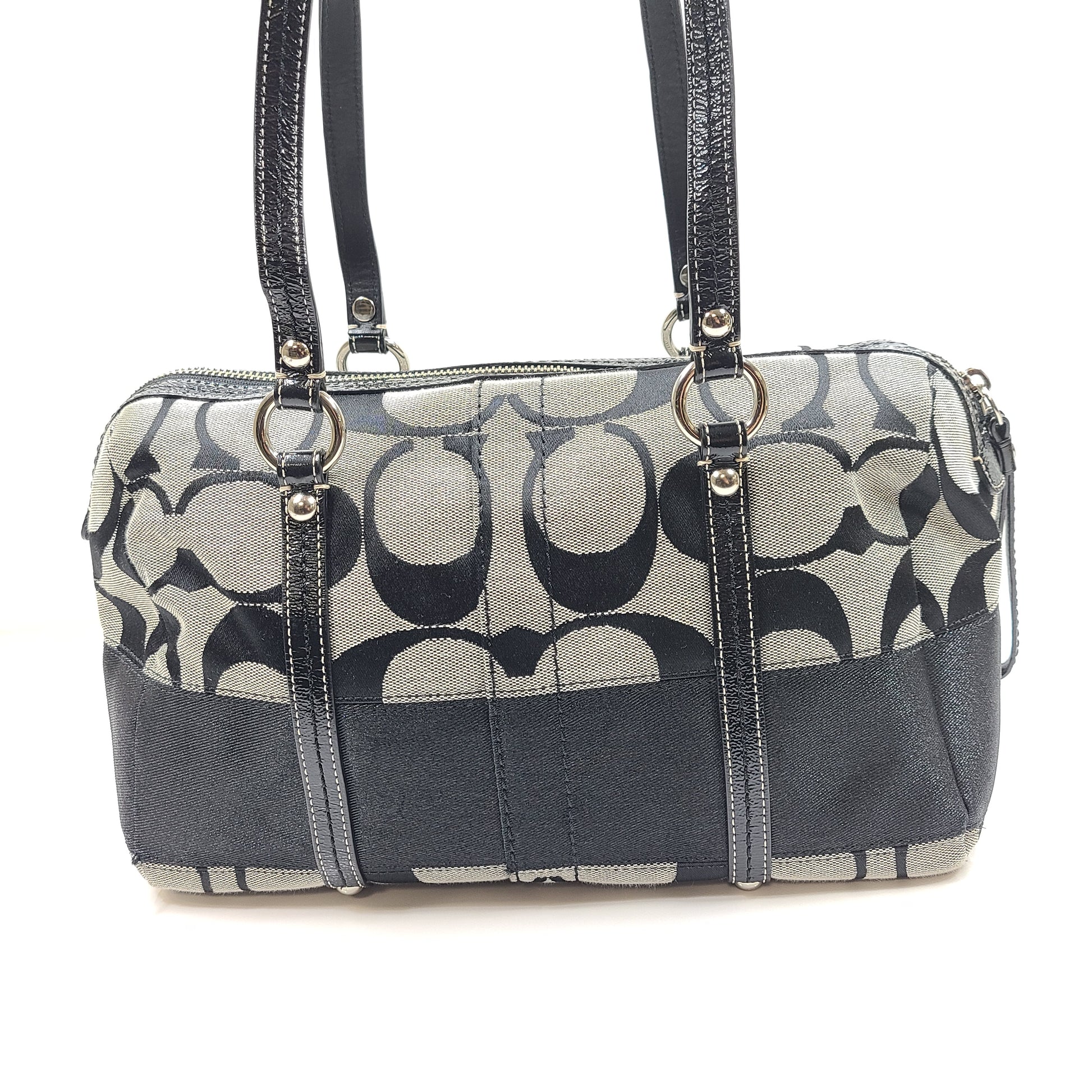 Gray and black Coach satchel with double handles, zip closure, and an interior patch stating handcrafted Coach leather.