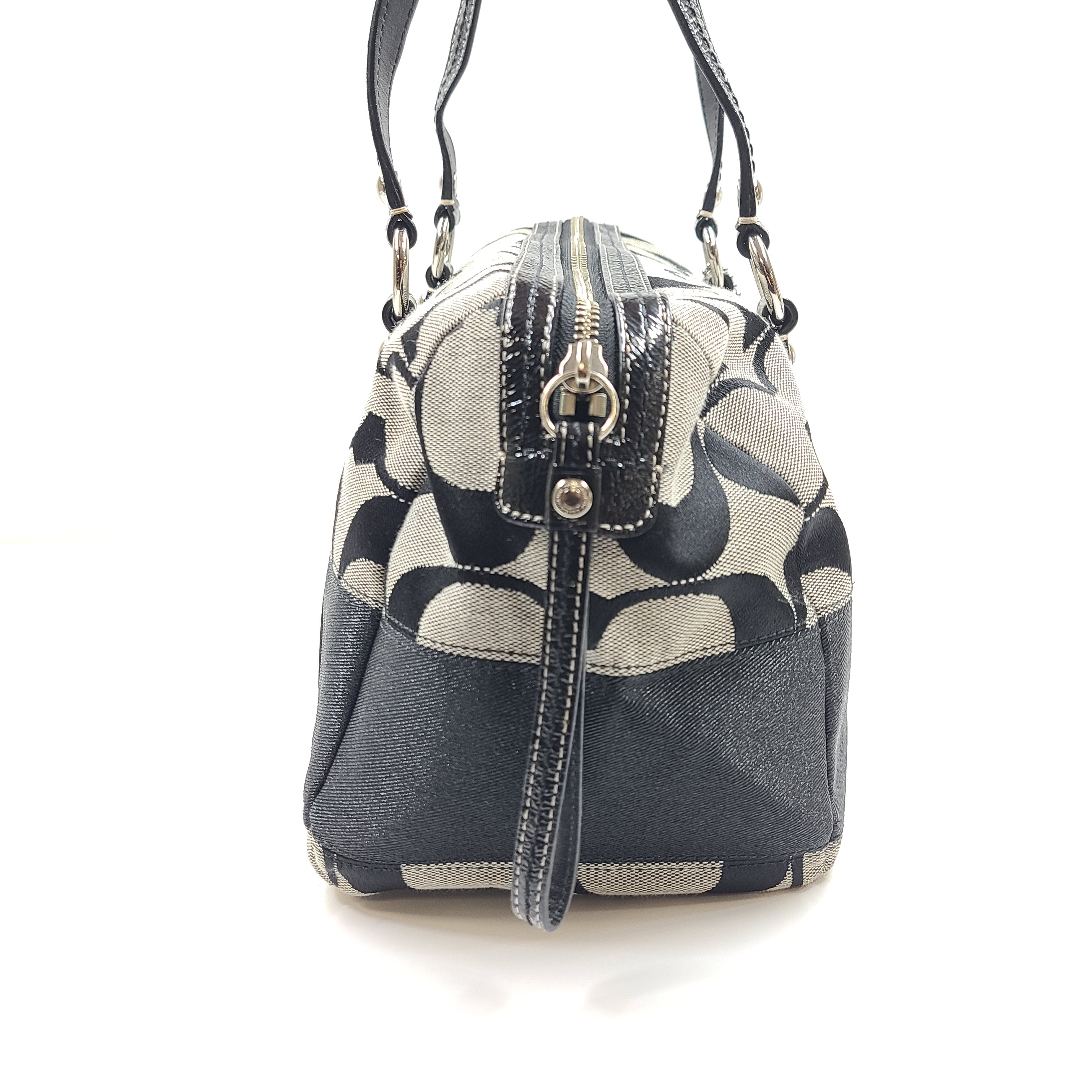 Gray and black Coach satchel with double handles, zip closure, and an interior patch stating handcrafted Coach leather.