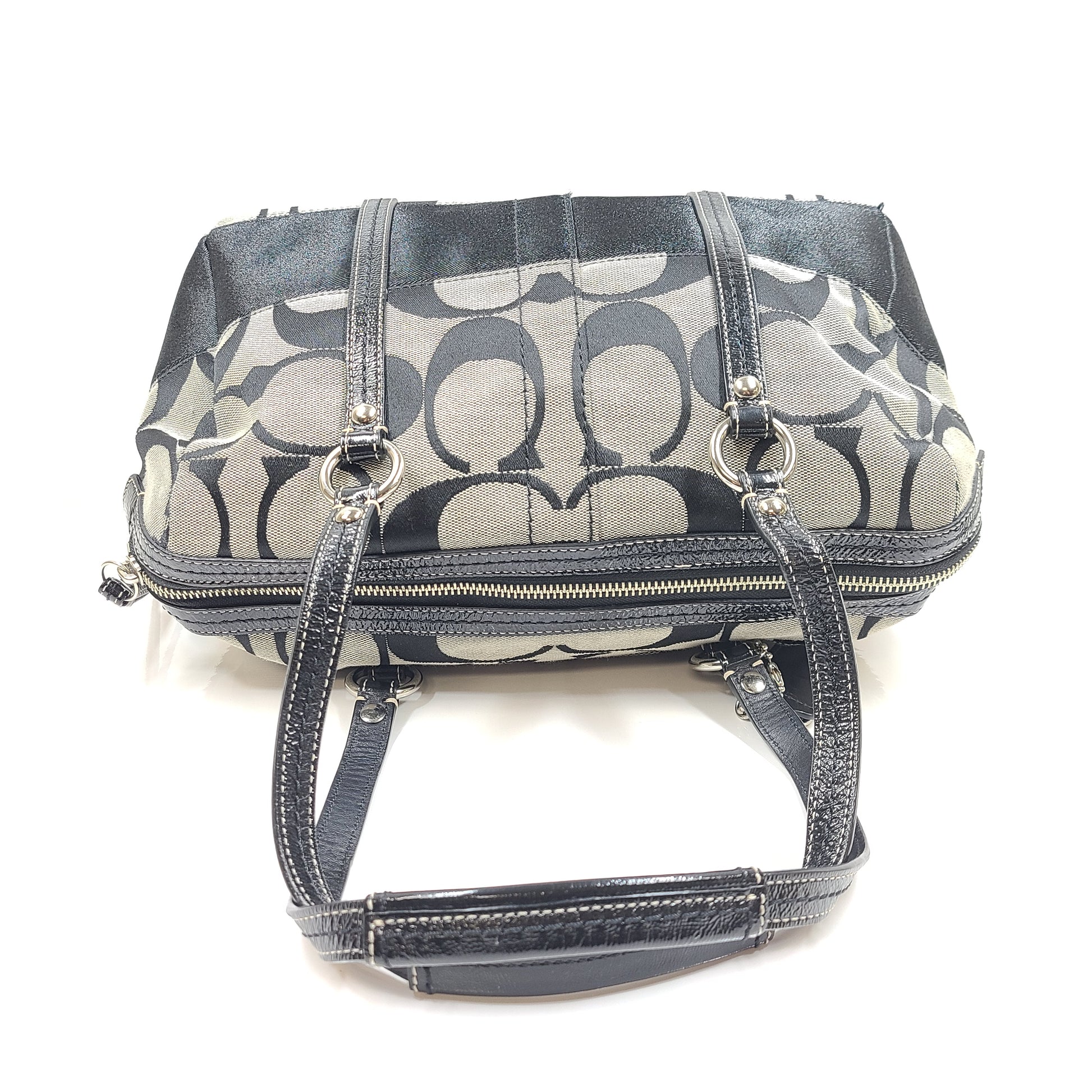 Gray and black Coach satchel with double handles, zip closure, and an interior patch stating handcrafted Coach leather.