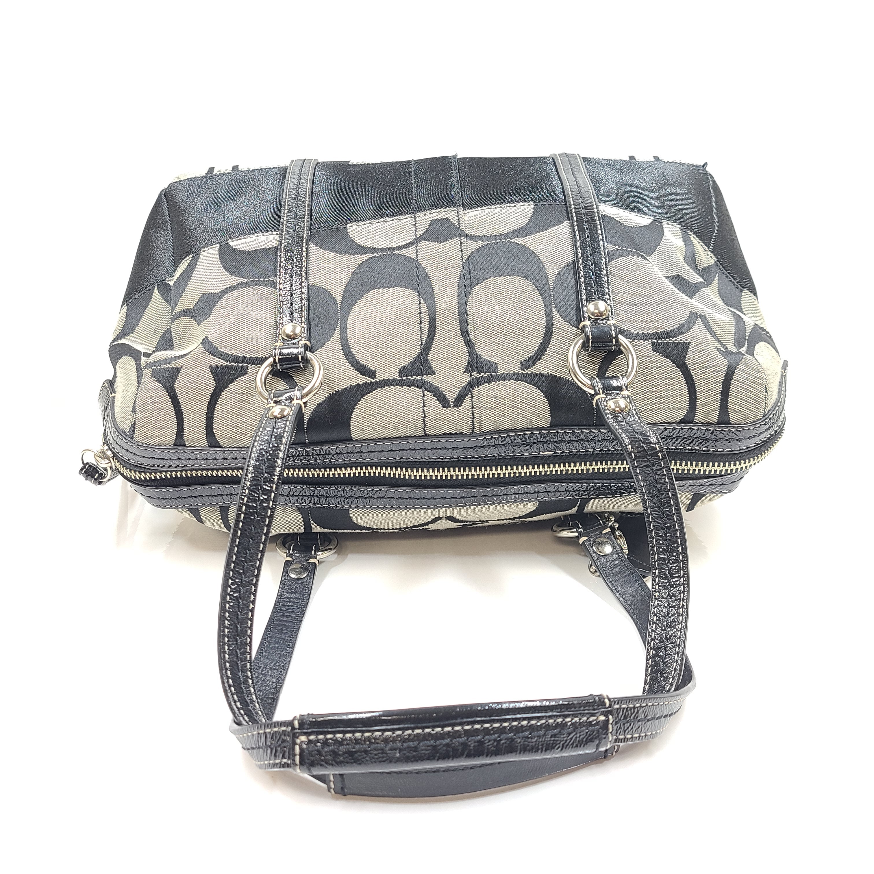 Gray and black Coach satchel with double handles, zip closure, and an interior patch stating handcrafted Coach leather.