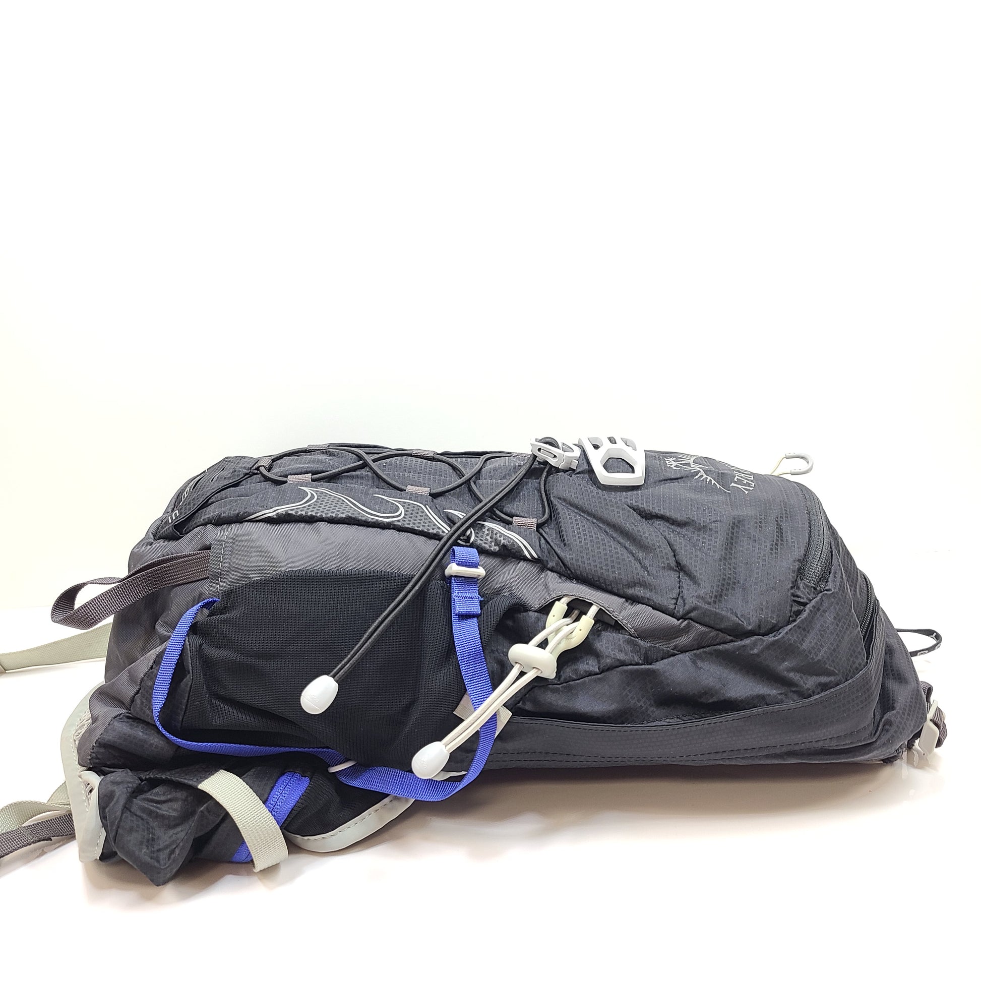 Compact Osprey Tempest 9 backpack in black, blue, and grey with Airscape back panel and adjustable straps for comfortable carry.