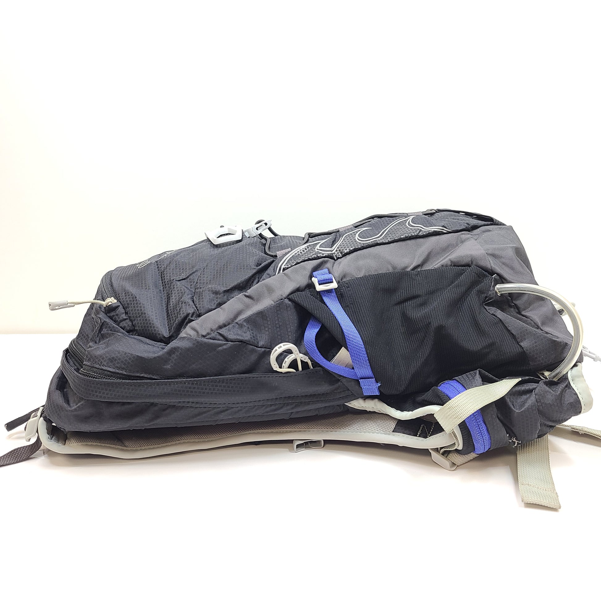 Compact Osprey Tempest 9 backpack in black, blue, and grey with Airscape back panel and adjustable straps for comfortable carry.