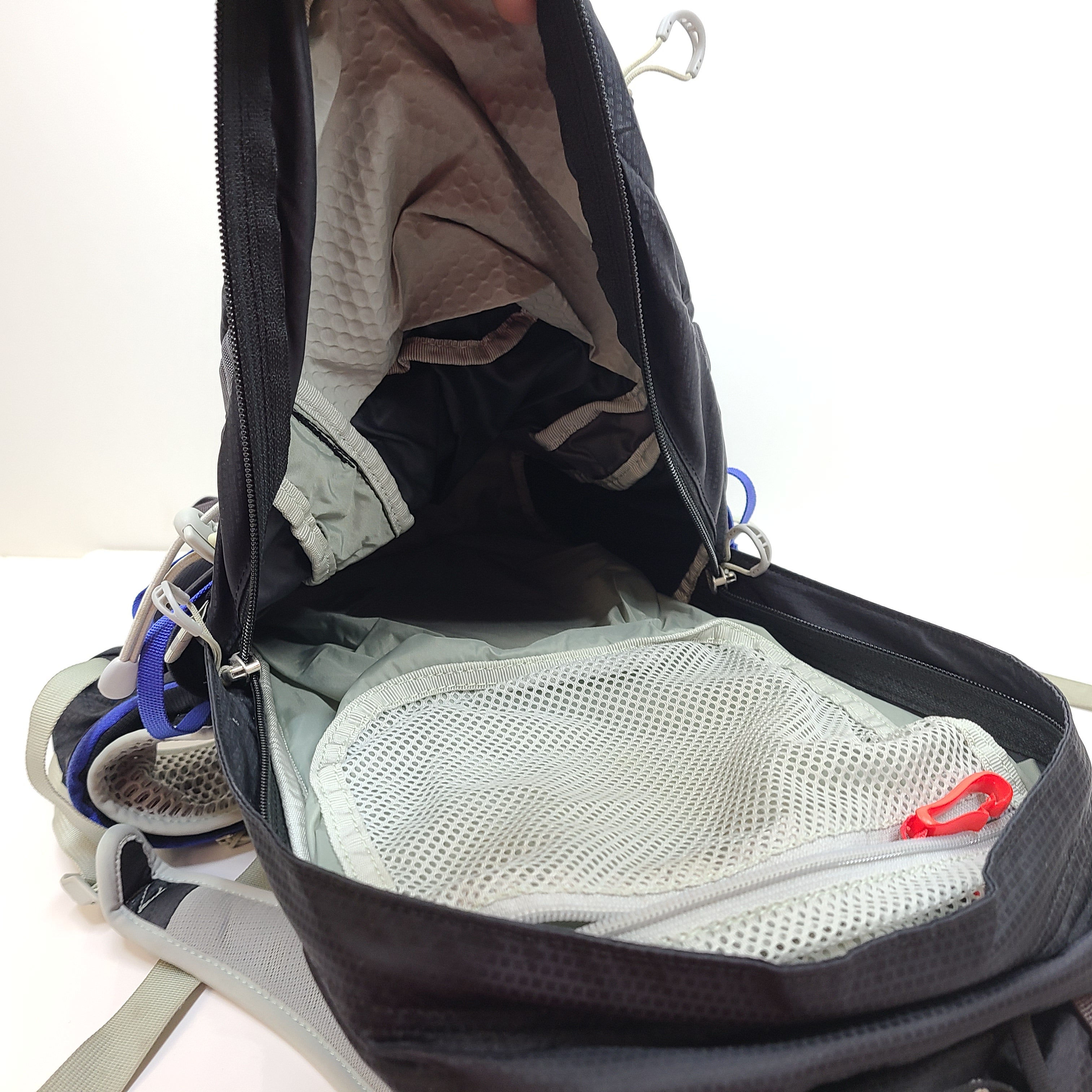 Compact Osprey Tempest 9 backpack in black, blue, and grey with Airscape back panel and adjustable straps for comfortable carry.