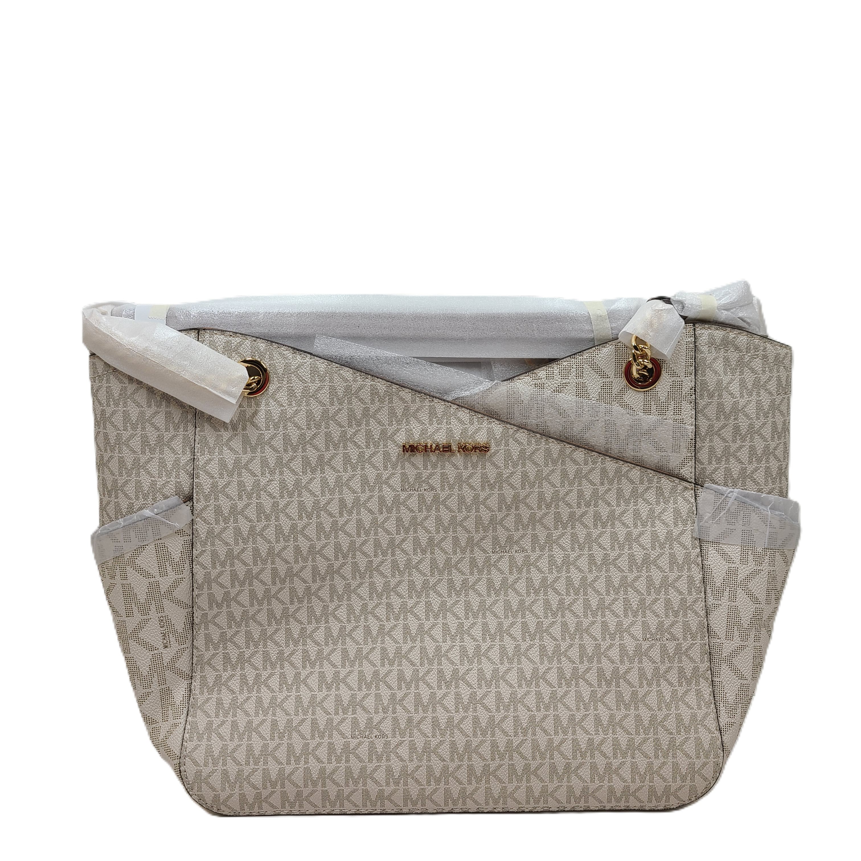 Michael Kors Jet Set Travel large chain shoulder tote in vanilla with signature logo and gold-tone chain detail.